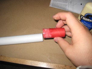 Rocket tube coupler smeared with glue, ready for insertion